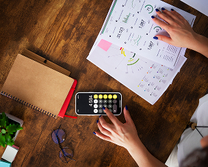 working desk with a calculator and graphs